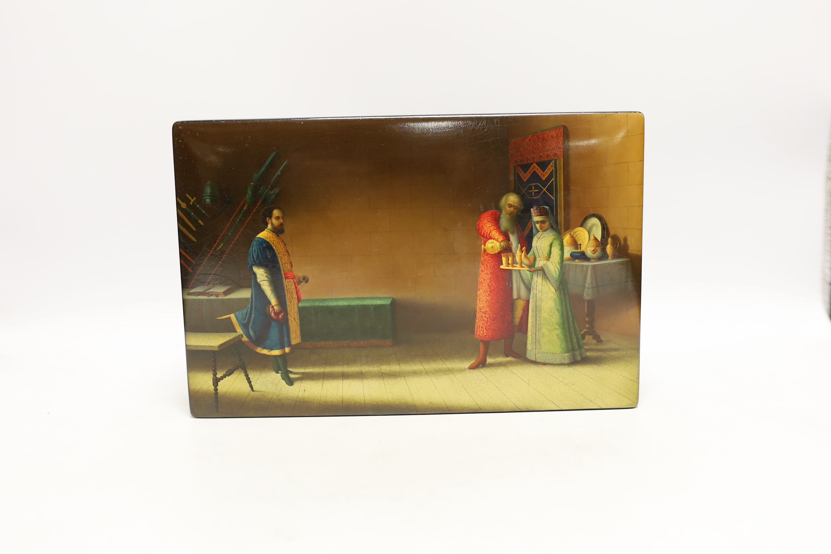 A large Russian lacquer box, by Lukutin, pre-1917, painted with a nobleman and guest in an interior, 26cm, Please note this lot attracts an additional import tax of 5% on the hammer price